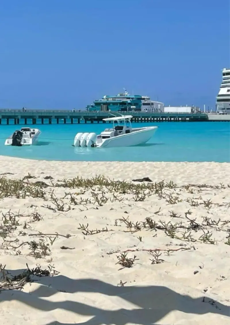 Slide: The Image of 2007 Donzi 35 ZF Open boat on turquoise water near sandy beach. - 8