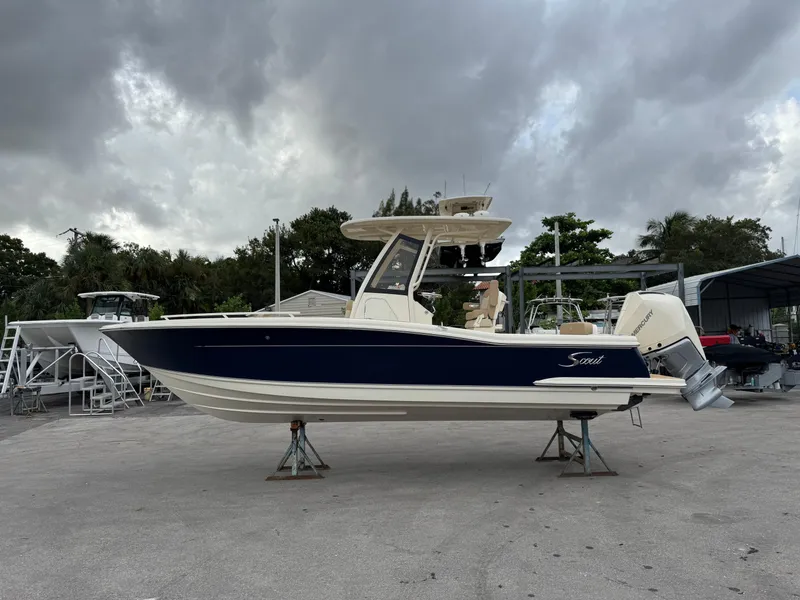 Slide: The Image of 2025 Scout 240 XSF boat on display under cloudy skies. - 0