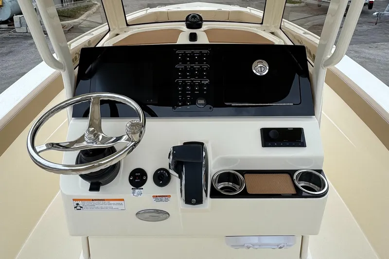 Slide: The Image of 2025 Scout 240 XSF boat dashboard with steering wheel and controls. - 1