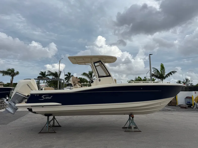 Slide: The Image of 2025 Scout 240 XSF boat on display under cloudy sky. - 3