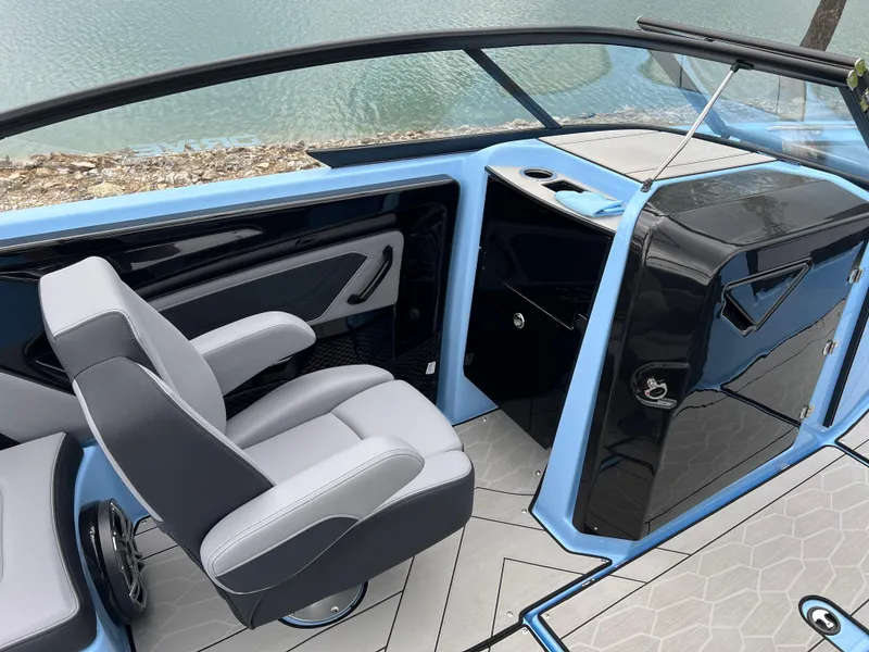 Slide: The Image of 2025 Yamaha Boats 255XD cockpit with sleek design and modern seating by the water. - 10