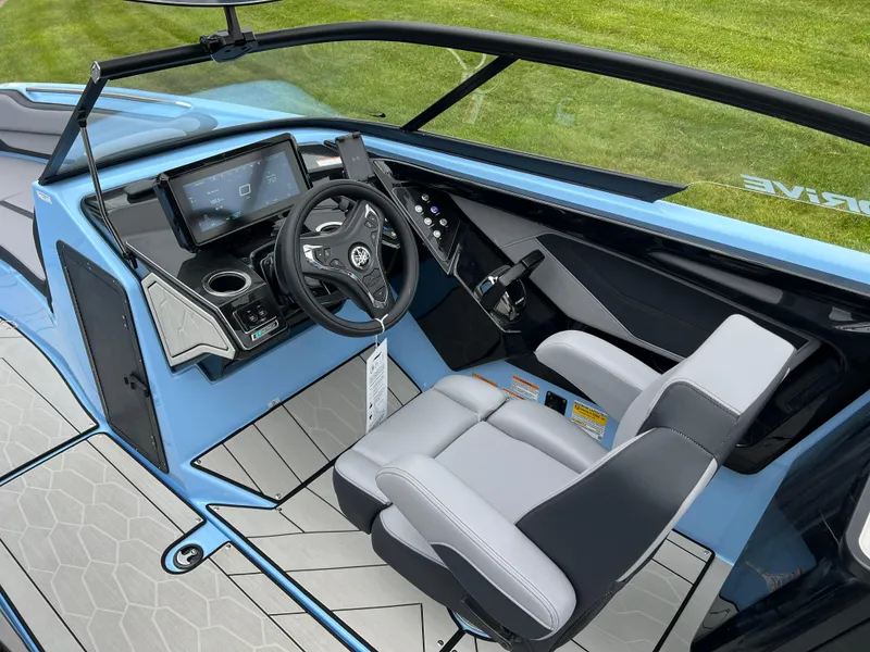 Slide: The Image of 2025 Yamaha Boats 255XD cockpit with modern controls, blue and gray seating, and sleek dashboard design. - 11