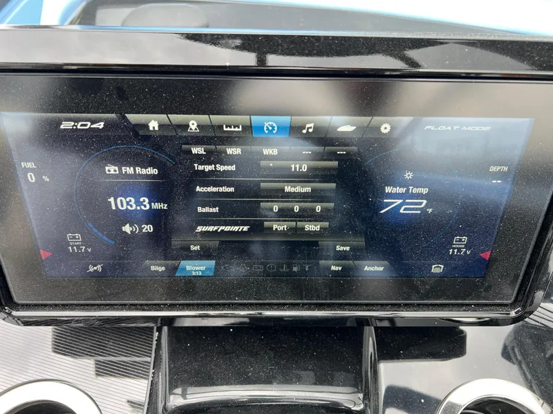 Slide: The Image of Dashboard display of 2025 Yamaha Boats 255XD showing radio, speed, and water temperature. - 13