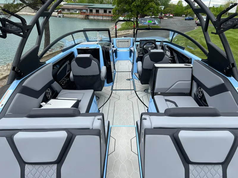 Slide: The Image of 2025 Yamaha Boats 255XD interior, featuring modern seating and sleek design by the water. - 7