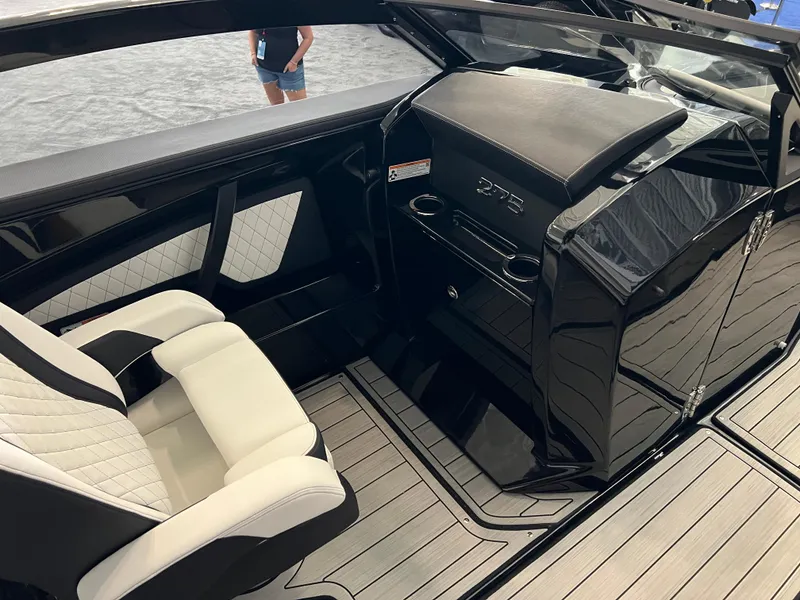 Slide: The Image of Interior of 2025 Yamaha Boats 275 SD, featuring sleek black and white seating. - 11