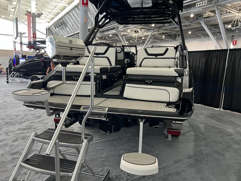 Slide: The Image of 2025 Yamaha Boats 275 SD interior at a boat show, featuring luxurious seating and modern design. - 4