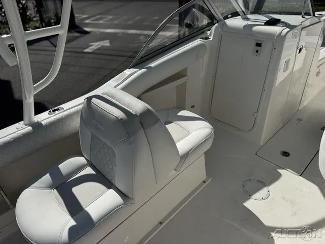 Slide: The Image of 2025 Key West 239 DFS boat interior with Garmin navigation system and white seating. - 15