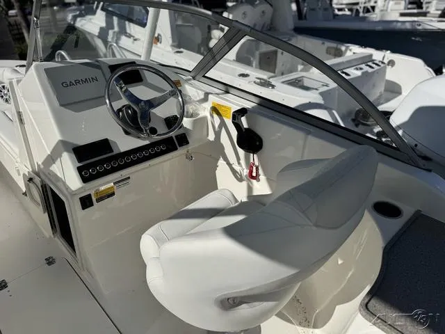 Slide: The Image of Key West 239 DFS 2025 boat dashboard with Garmin navigation system and steering wheel. - 16