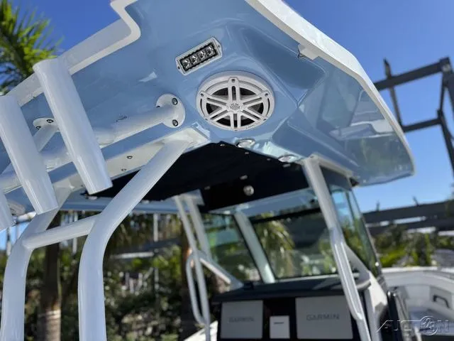 Slide: The Image of 2025 Blackfin 272CC boat with blue canopy and speaker system. - 16