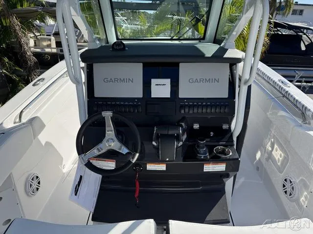 Slide: The Image of 2025 Blackfin 272CC boat cockpit with Garmin navigation system and steering wheel. - 19