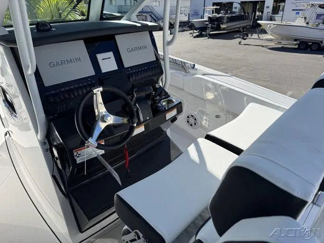 Slide: The Image of 2025 Blackfin 272CC boat cockpit with dual Garmin displays and sleek seating. - 22
