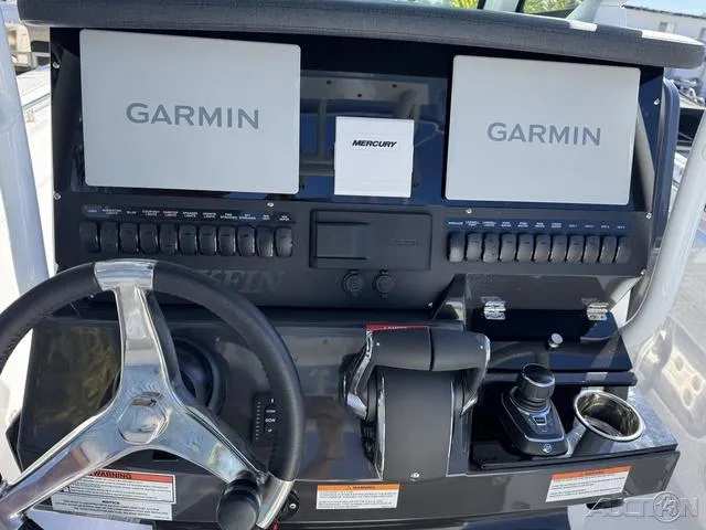 Slide: The Image of 2025 Blackfin 272CC boat dashboard with Garmin displays and Mercury controls. - 23