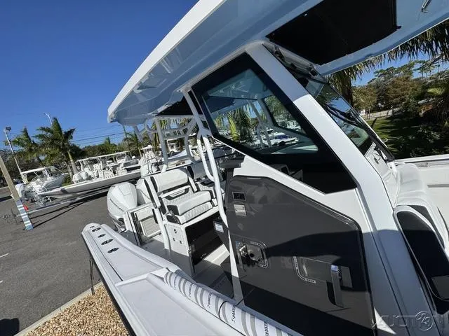 Slide: The Image of 2025 Blackfin 272CC boat with sleek design and modern features, docked outdoors. - 36