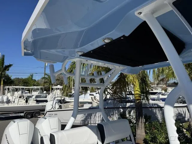 Slide: The Image of 2025 Blackfin 272CC boat with sleek design and modern features, docked under clear skies. - 38