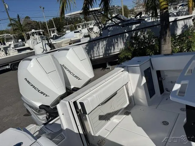 Slide: The Image of 2025 Blackfin 272CC boat with dual Mercury engines in a marina setting. - 41