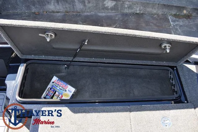 Slide: The Image of Open storage compartment in 2025 Bass Cat Cougar FTD boat with Thayer's Marine logo. - 16