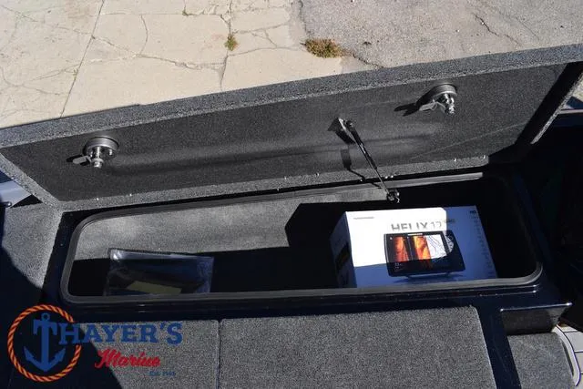 Slide: The Image of 2025 Bass Cat Cougar FTD storage compartment with electronics box, Thayer's Marine logo visible. - 18