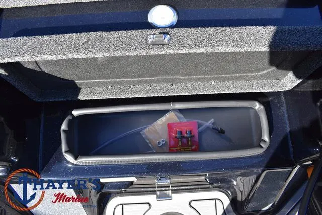 Slide: The Image of 2025 Bass Cat Cougar FTD storage compartment with accessories, Thayer's Marine logo visible. - 22