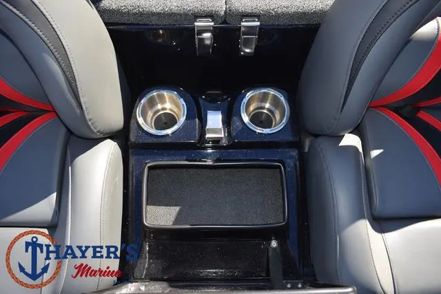 Slide: The Image of 2025 Bass Cat Cougar FTD boat interior with cup holders and storage compartment. - 27