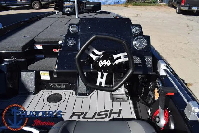 Slide: The Image of 2025 Bass Cat Cougar FTD boat dashboard with steering wheel and gauges. - 32
