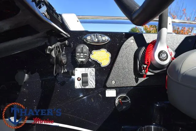 Slide: The Image of 2025 Bass Cat Cougar FTD boat dashboard with controls and steering wheel. - 34