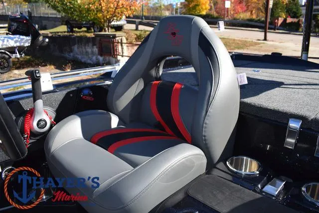 Slide: The Image of 2025 Bass Cat Cougar FTD boat seat with red and gray design, Thayer's Marine logo. - 35