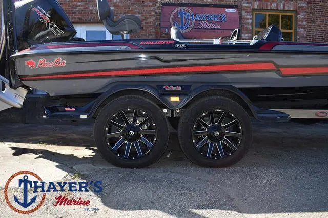 Slide: The Image of 2025 Bass Cat Cougar FTD boat with sleek design and custom wheels at Thayer's Marine. - 6
