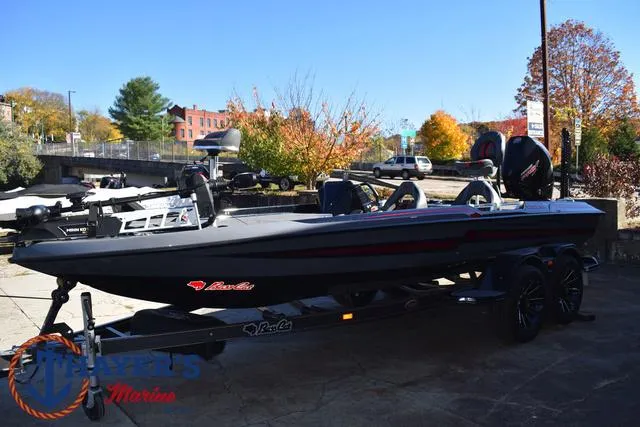 Slide: The Image of 2025 Bass Cat Cougar FTD boat on trailer, outdoor setting, autumn trees in background. - 9