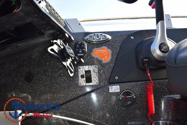 Slide: The Image of 2025 Bass Cat Cougar FTD boat dashboard with controls and warning sticker. - 12