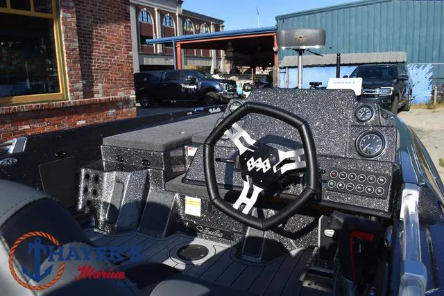 Slide: The Image of 2025 Bass Cat Cougar FTD boat dashboard with steering wheel and controls. - 14