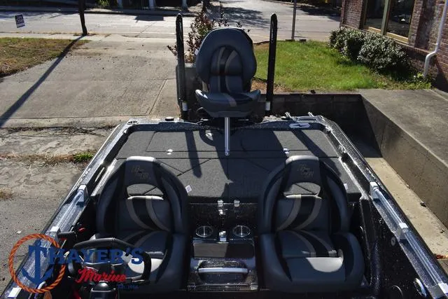 Slide: The Image of 2025 Bass Cat Cougar FTD boat with three seats, parked outdoors. - 15