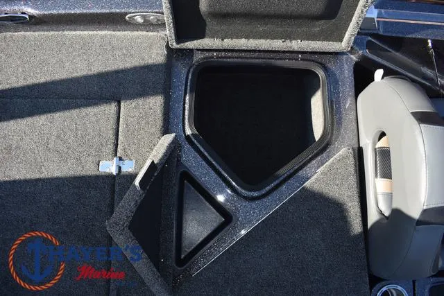 Slide: The Image of 2025 Bass Cat Cougar FTD boat storage compartment with open lid, showcasing interior space. - 18