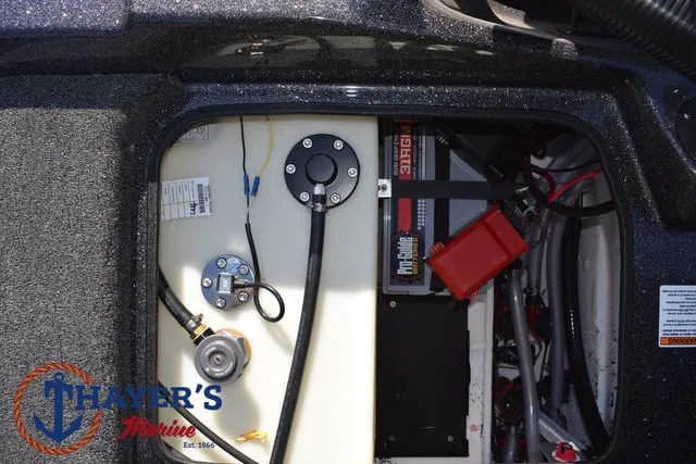 Slide: The Image of 2025 Bass Cat Cougar FTD boat compartment with wiring and battery components. - 19