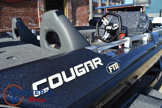 Slide: The Image of 2025 Bass Cat Cougar FTD boat interior with steering wheel and seats. - 30