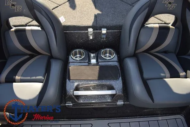 Slide: The Image of 2025 Bass Cat Cougar FTD interior with dual cup holders and sleek seating design. - 6