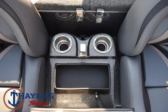 Slide: The Image of 2025 Bass Cat Cougar FTD interior with cup holders and storage compartment. - 7