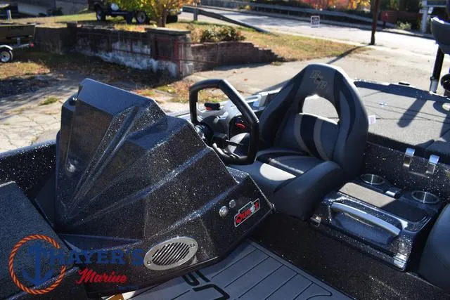 Slide: The Image of 2025 Bass Cat Cougar FTD boat interior with steering wheel and seating. - 8