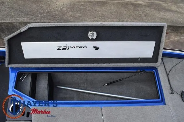 Slide: The Image of 2018 Nitro Z21 boat storage compartment open, showcasing interior space and design. - 13