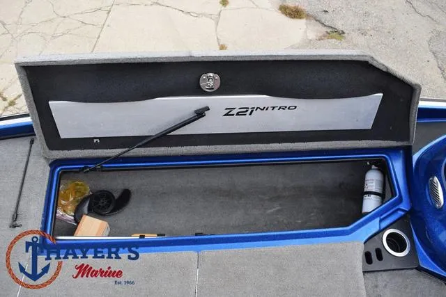 Slide: The Image of Open storage compartment of 2018 Nitro Z21 boat with Thayer's Marine logo. - 14