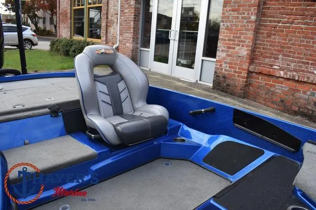 Slide: The Image of 2018 Nitro Z21 boat interior with gray seating and blue accents. - 21