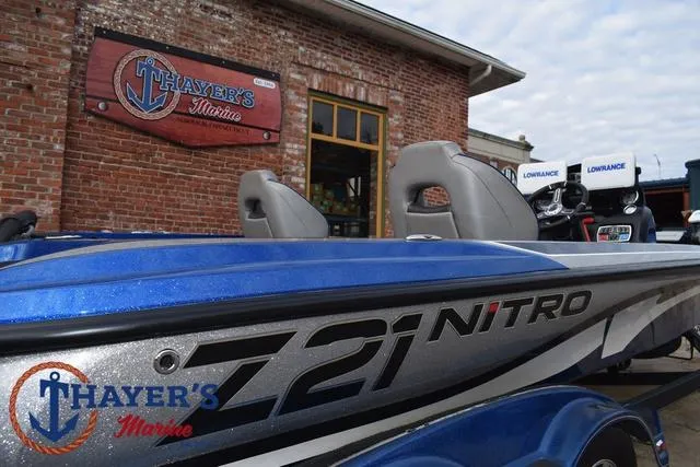 Slide: The Image of 2018 Nitro Z21 boat at Thayer's Marine dealership, featuring blue and silver design. - 38