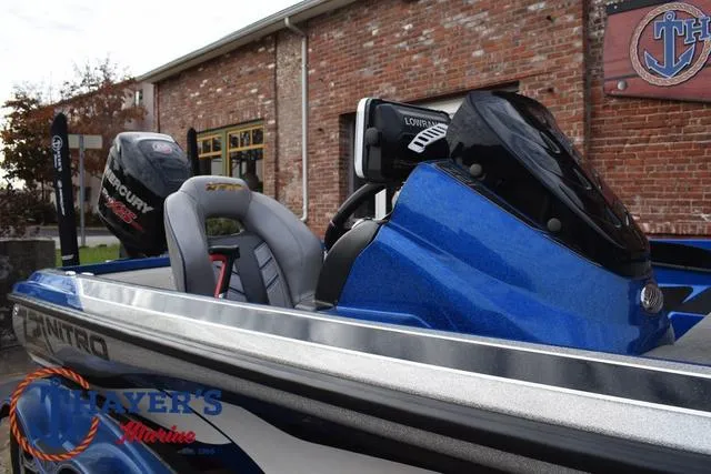 Slide: The Image of 2018 Nitro Z21 boat with Mercury engine, blue exterior, parked near a brick building. - 39