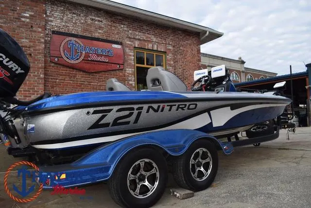 Slide: The Image of 2018 Nitro Z21 boat parked outside Thayer's Marine, featuring sleek design and dual-axle trailer. - 41