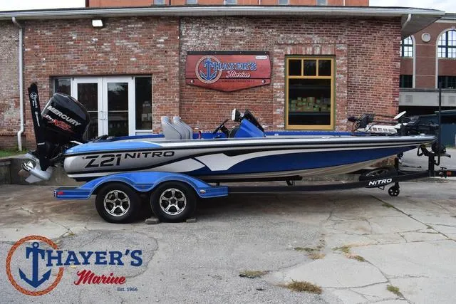 Slide: The Image of 2018 Nitro Z21 boat in blue and silver at Thayer's Marine dealership. - 43