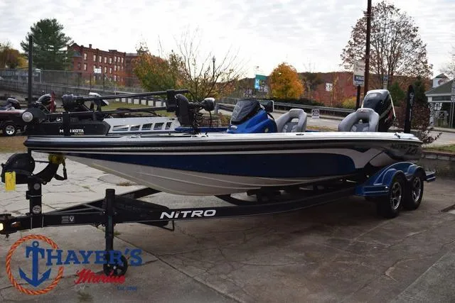 Slide: The Image of 2018 Nitro Z21 boat on trailer, parked outdoors, autumn background. - 7