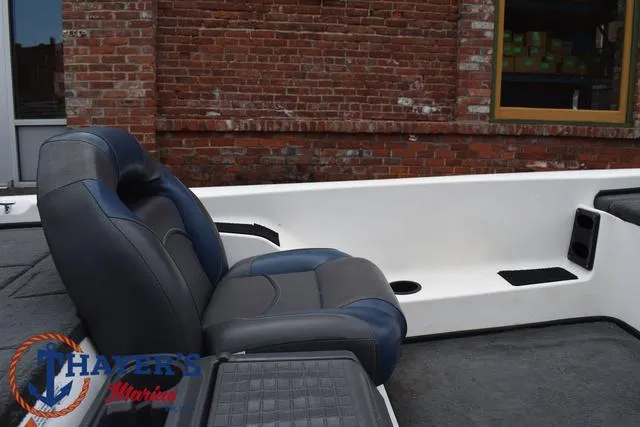 Slide: The Image of 2007 Stratos 176XT boat interior with blue and gray seating, brick wall background. - 19