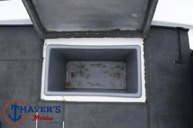Slide: The Image of Open storage compartment on 2007 Stratos 176XT boat deck, Thayer's Marine logo visible. - 27