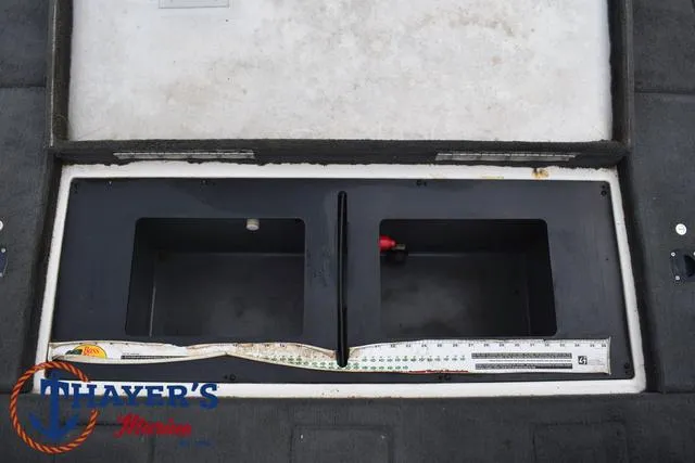 Slide: The Image of Open storage compartment in a 2007 Stratos 176XT boat with measuring tape. - 28