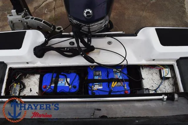 Slide: The Image of 2007 Stratos 176XT boat battery compartment with dual blue batteries and wiring. - 29