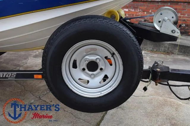 Slide: The Image of 2007 Stratos 176XT boat trailer wheel with Thayer's Marine logo. - 8